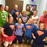 Team members wearing emoji t-shirts