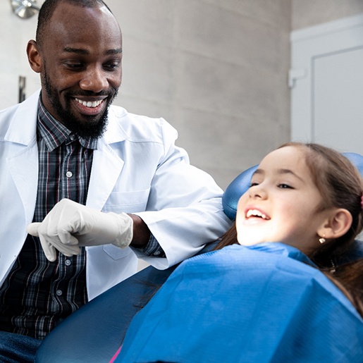 young girl smiling while visiting dentist