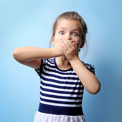 Child covering her mouth