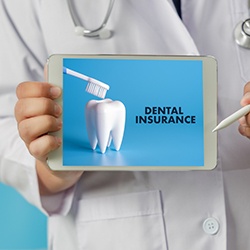 Dentist holding table that reads Dental Insurance