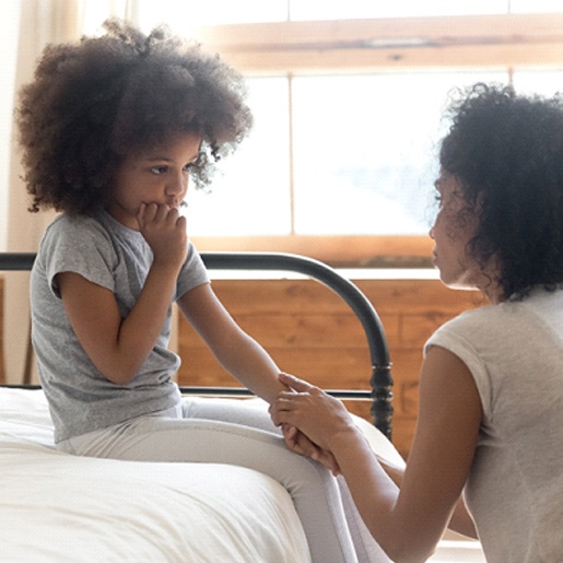 Child and parent having a talk about thumb sucking