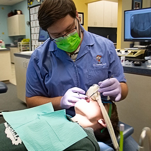 Dentist performing dental treatment