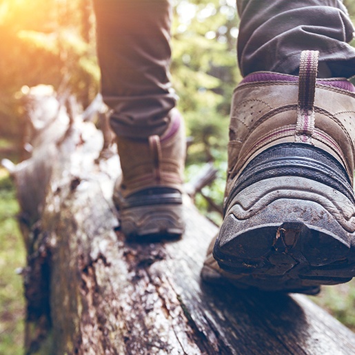 Person walking across a log