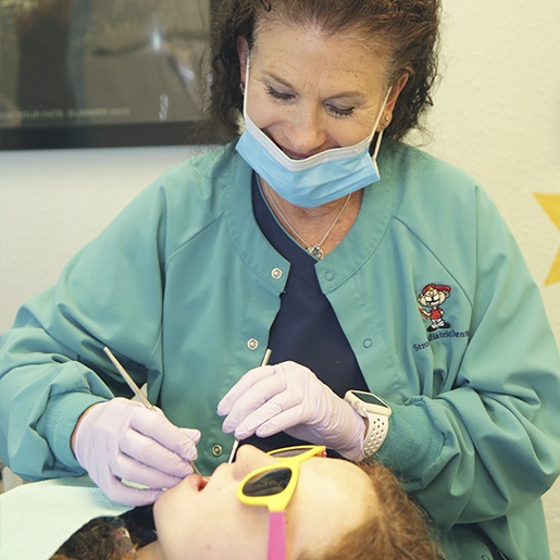 Team member examining child's smile