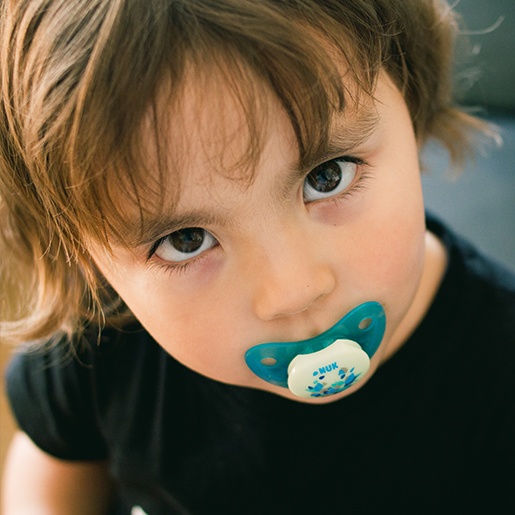 Toddler using a pacifier