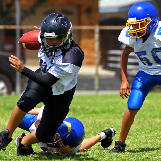 Kids with mouthguards playing football