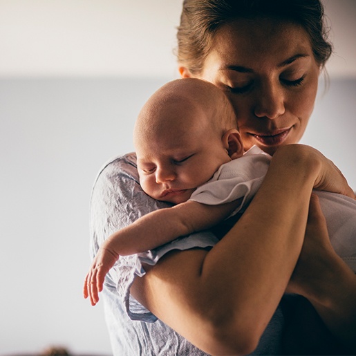 Mother holding sleeping baby