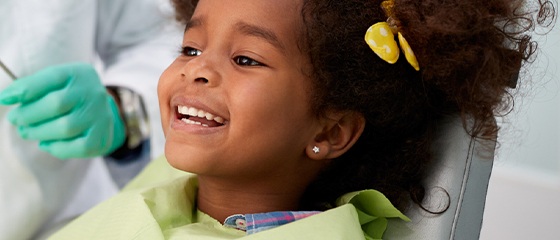 Smiling young girl in dental chair