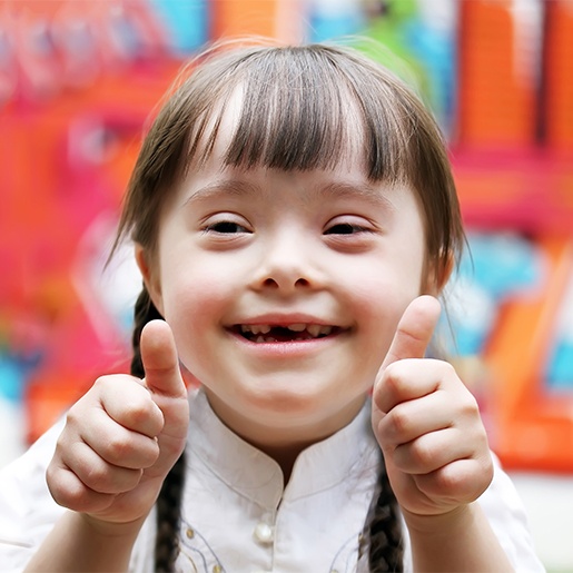 Little girl giving two thumbs up