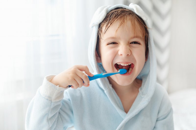 A happy child brushing their teeth