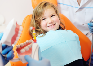 a child smiling while visiting their pediatric dentist