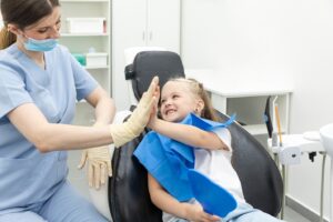 Kid high fiving their dentist.